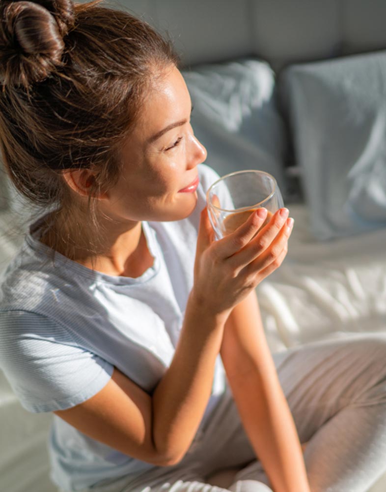 happy woman drinking hot coffee mug in morning
